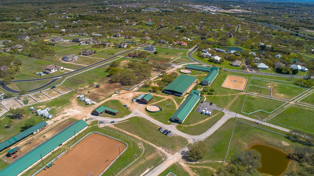 Wide aerial view of the equestrian facility among the Texas Hill Country landscape