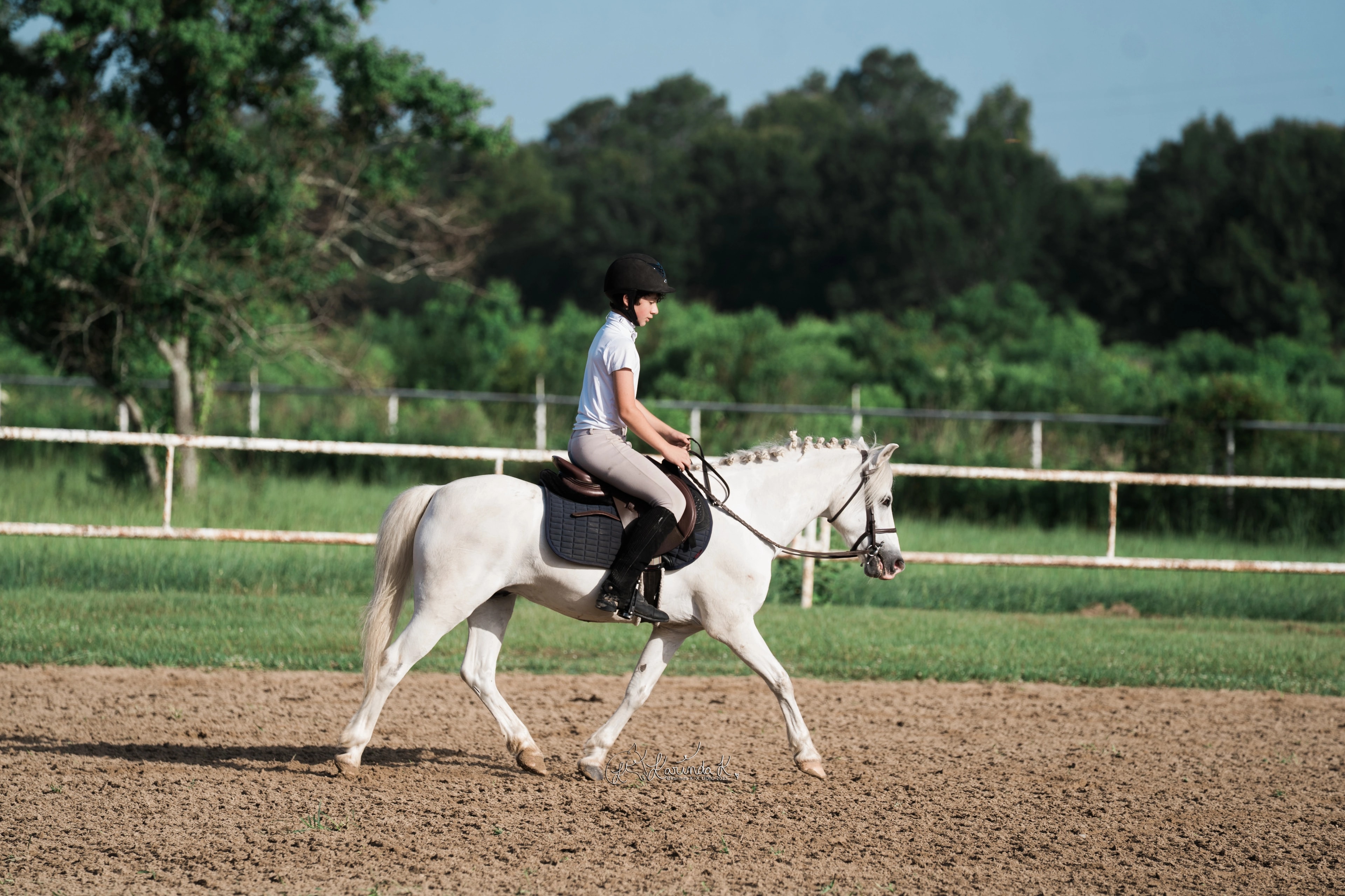 A young rider developing balance on a carefully prepared pony